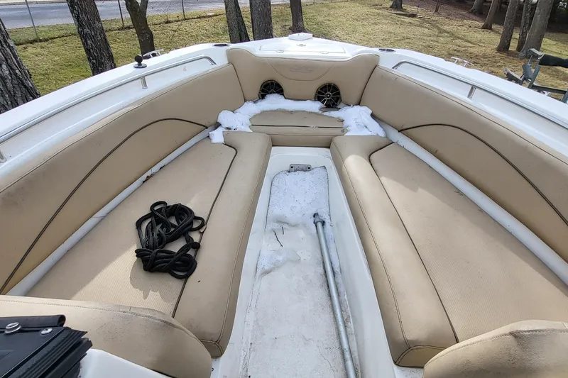 Slide: The Image of 2018 NauticStar 2302 Legacy boat interior with portable toilet on wooden floor. - 6