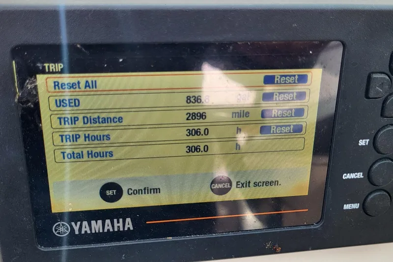 Slide: The Image of 2018 NauticStar 2302 Legacy boat interior with steering wheel and seating. - 7