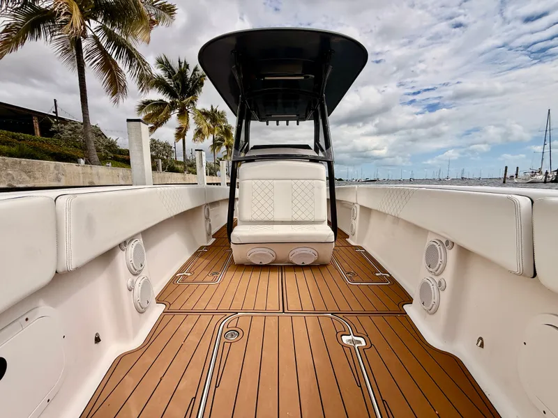 Slide: The Image of 2008 Carrera Powerboats 32 Center Console with teak flooring and palm trees. - 12