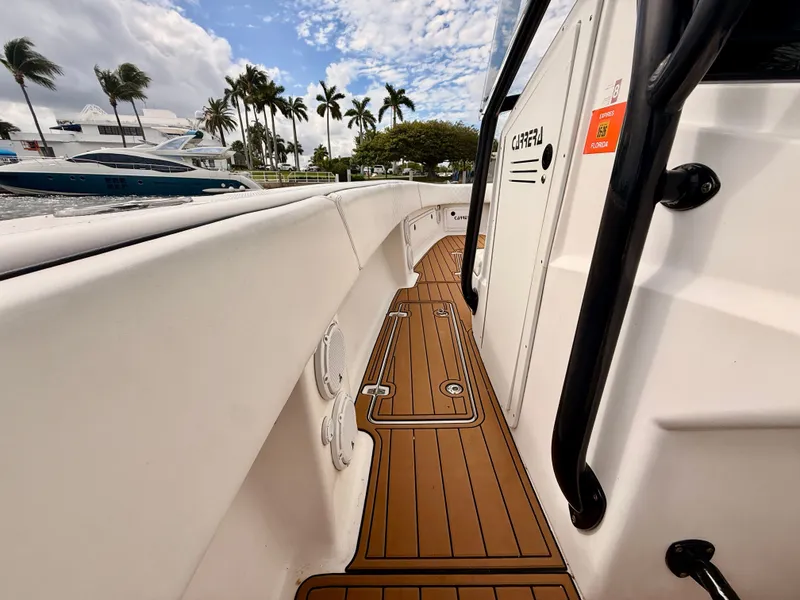 Slide: The Image of 2008 Carrera Powerboats 32 Center Console, deck view with palm trees in background. - 8