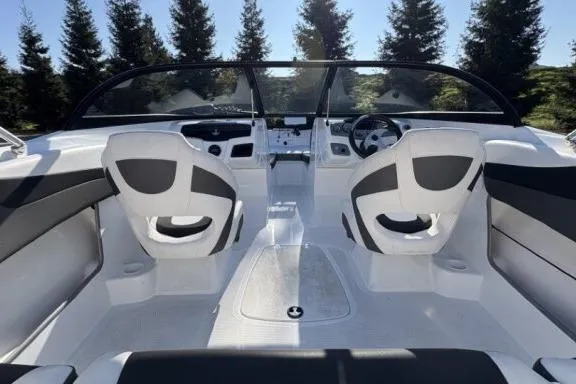 Slide: The Image of 2022 Tahoe 200 S boat interior with dual seats and sleek dashboard design. - 11