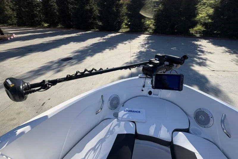 Slide: The Image of 2022 Tahoe 200 S boat with Lowrance electronics and trolling motor, parked outdoors. - 13