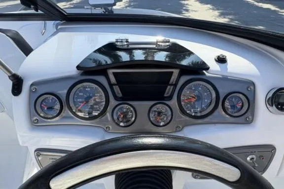 Slide: The Image of Dashboard of a 2022 Tahoe 200 S boat with multiple gauges and steering wheel. - 15