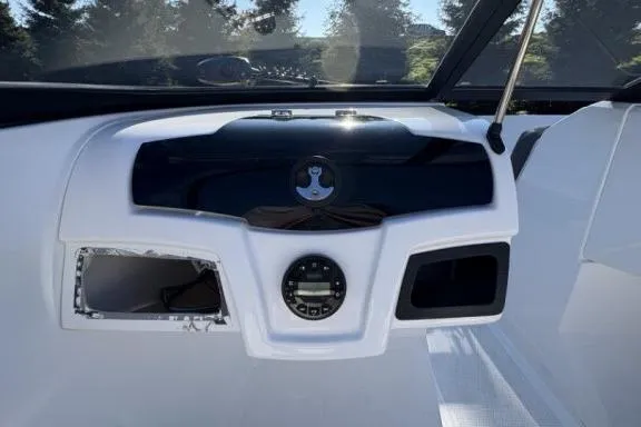 Slide: The Image of Dashboard of a 2022 Tahoe 200 S boat with control panel and steering wheel. - 17
