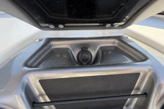 Slide: The Image of 2022 Tahoe 200 S boat storage compartment with secure latch and sleek design. - 19