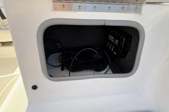 Slide: The Image of Storage compartment in a 2022 Tahoe 200 S boat with cables and equipment. - 20