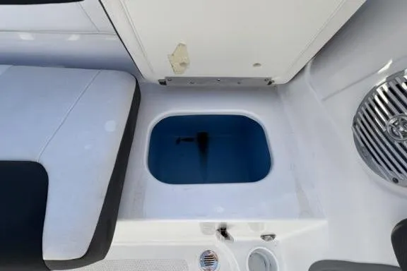 Slide: The Image of 2022 Tahoe 200 S boat interior with seating and storage compartment. - 23