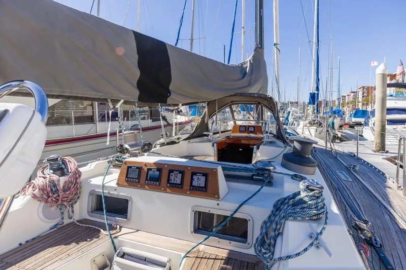 Slide: The Image of 1983 Baltic 42 DP sailboat cockpit with navigation instruments and ropes in a marina. - 15