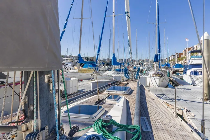 Slide: The Image of Sailboats docked at marina, featuring a 1983 Baltic 42 DP yacht. - 17