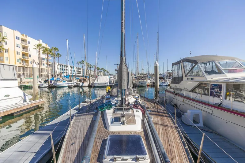 Slide: The Image of Baltic 42 DP sailboat docked in a sunny marina, surrounded by other boats. - 20