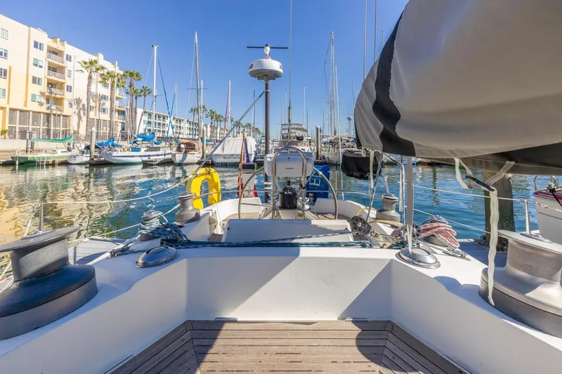 Slide: The Image of Baltic 42 DP sailboat from 1983 docked in a sunny marina. - 22