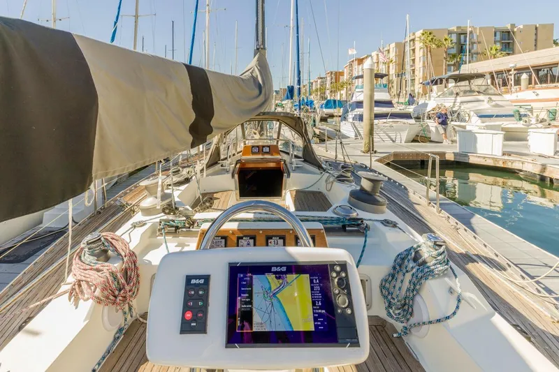 Slide: The Image of 1983 Baltic 42 DP sailboat cockpit with navigation system, docked in a marina. - 24