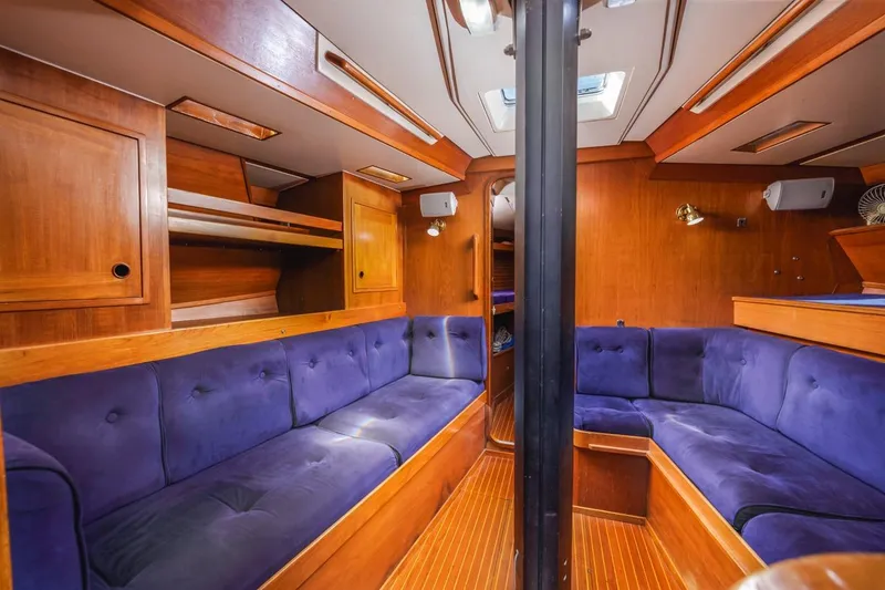 Slide: The Image of Luxurious interior of 1983 Baltic 42 DP yacht with plush blue seating and wooden finishes. - 26