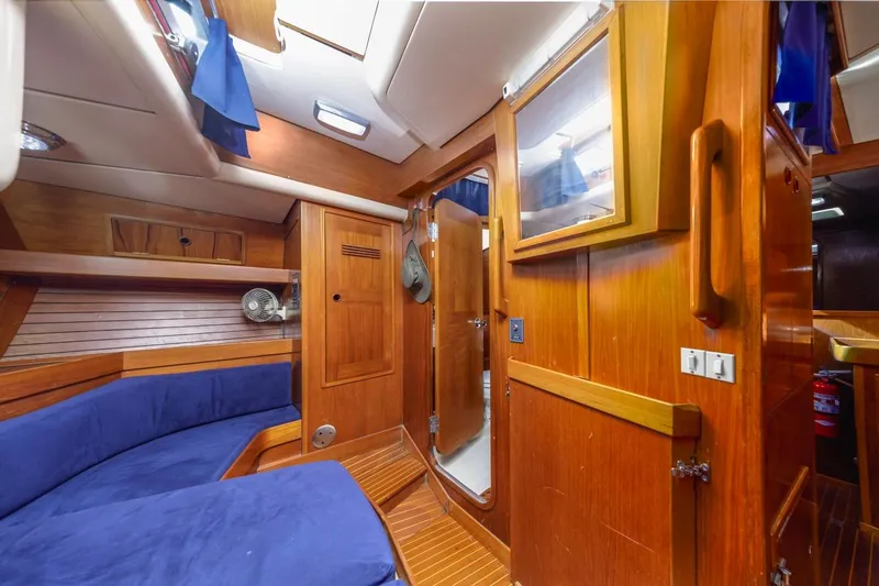 Slide: The Image of Interior of 1983 Baltic 42 DP yacht with wooden finish and blue seating. - 38