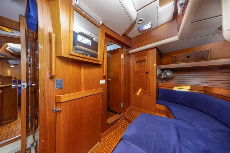 Slide: The Image of Luxurious 1983 Baltic 42 DP yacht interior with wooden finish and blue seating. - 39