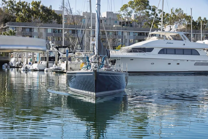 Slide: The Image of Baltic 42 DP sailboat from 1983 docked in a marina, surrounded by yachts. - 4