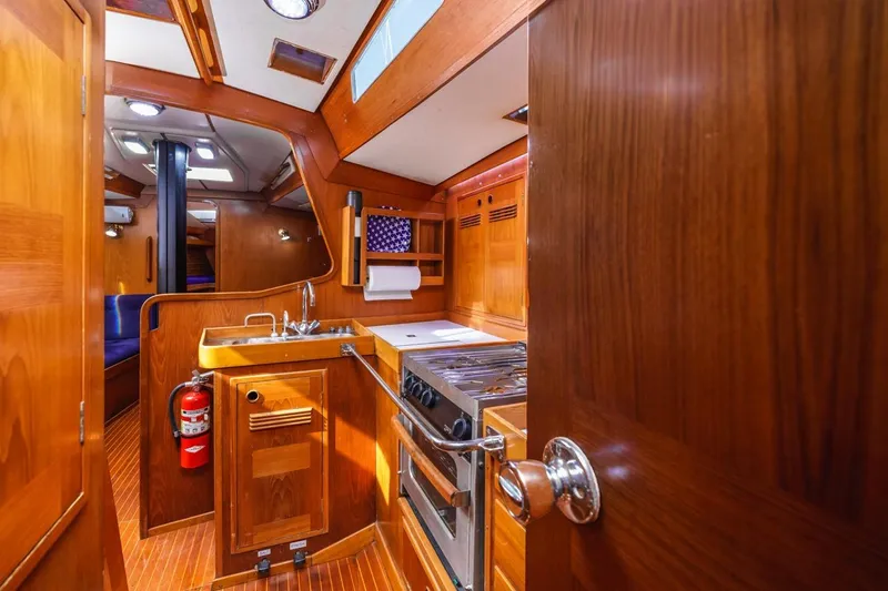 Slide: The Image of Interior of 1983 Baltic 42 DP yacht with wooden cabinetry and compact kitchen area. - 40