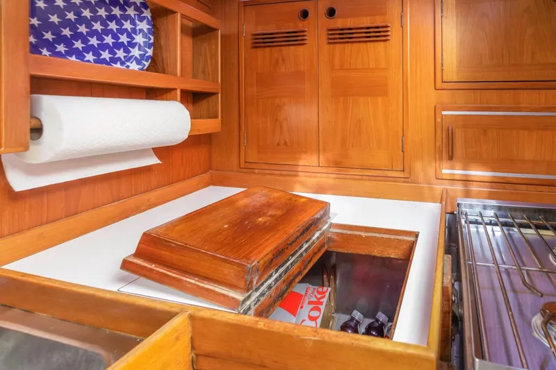 Slide: The Image of Wooden galley interior of 1983 Baltic 42 DP yacht with storage and paper towel holder. - 42