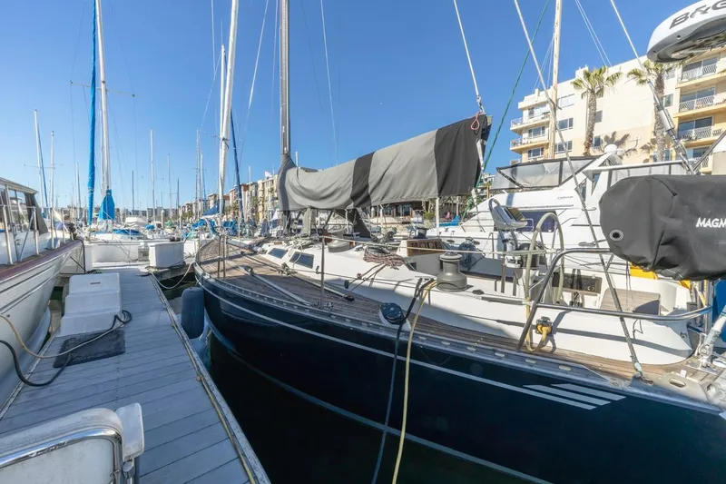 Slide: The Image of Sailboat Baltic 42 DP, 1983 model, docked in a marina under clear blue skies. - 9