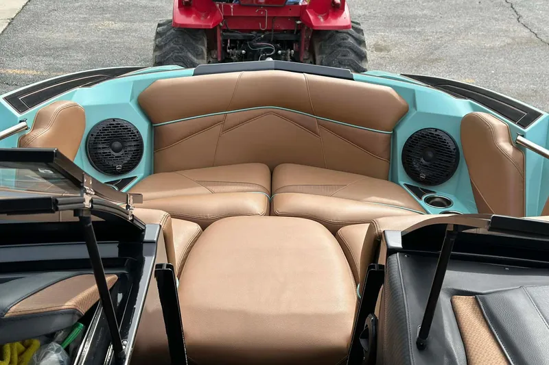 Slide: The Image of 2022 Centurion Fi23 boat interior with brown leather seats and built-in speakers. - 11