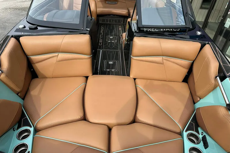 Slide: The Image of 2022 Centurion Fi23 boat interior with tan leather seats and teal accents. - 5