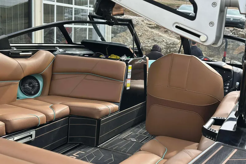 Slide: The Image of 2022 Centurion Fi23 boat interior with brown leather seating and modern design. - 9