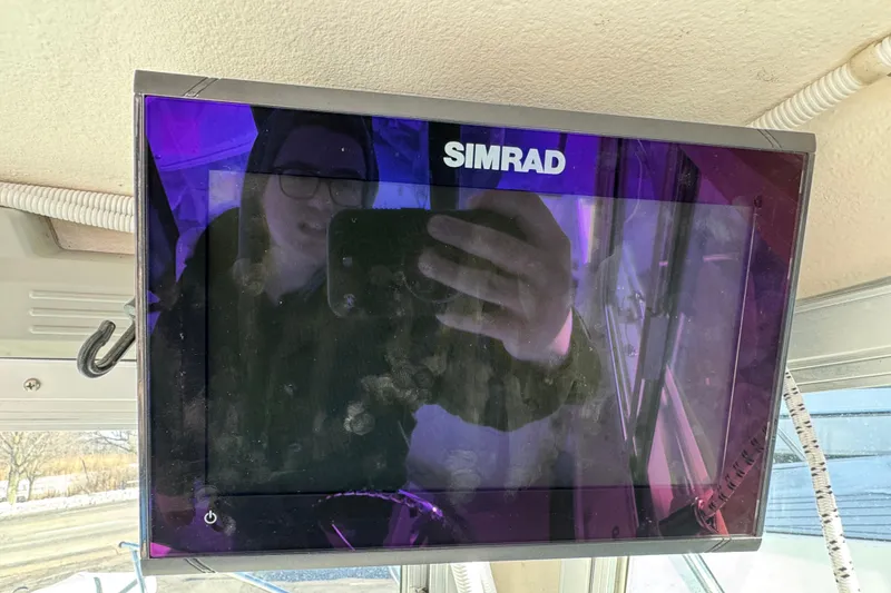 Slide: The Image of Simrad display on 2008 Steiger Craft 23 Miami boat, reflecting person taking photo. - 11