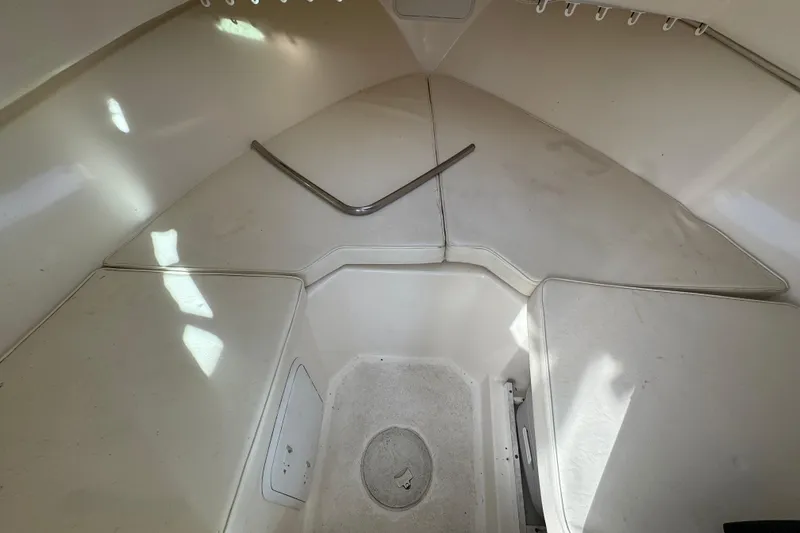 Slide: The Image of 2008 Steiger Craft 23 Miami boat interior with white seating and storage compartments. - 13