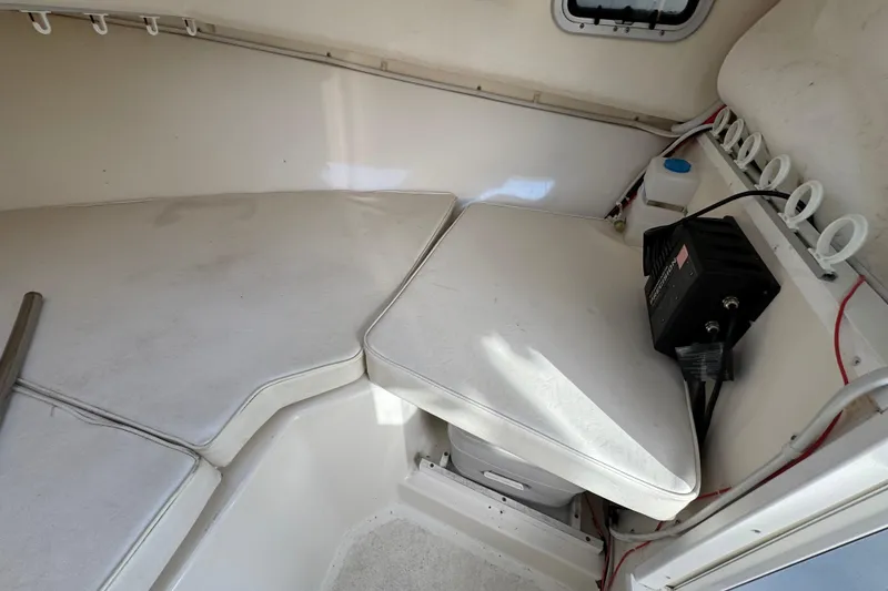 Slide: The Image of 2008 Steiger Craft 23 Miami cabin interior with cushioned seating and storage. - 14