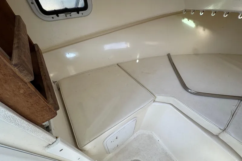 Slide: The Image of 2008 Steiger Craft 23 Miami cabin interior with seating and storage. - 15