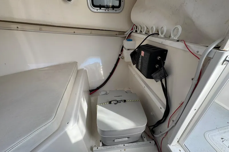 Slide: The Image of 2008 Steiger Craft 23 Miami cabin interior with portable toilet and electrical panel. - 16