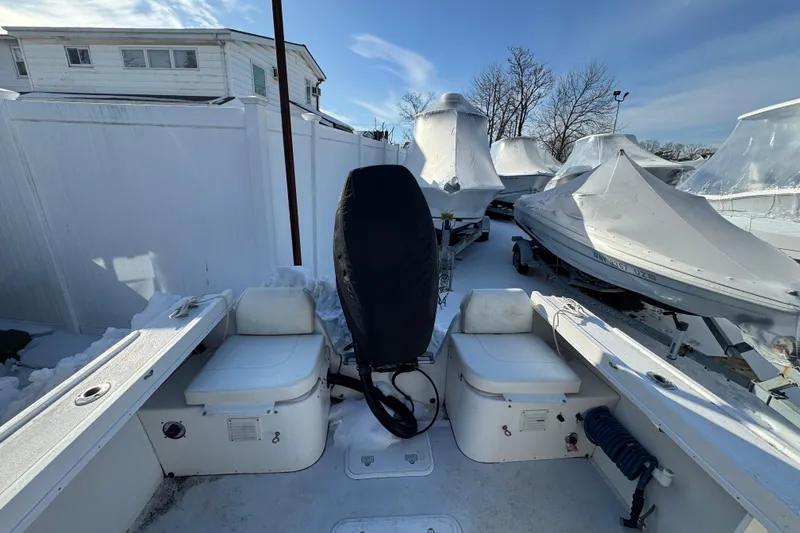 Slide: The Image of 2008 Steiger Craft 23 Miami boat in snowy storage, surrounded by covered boats. - 17