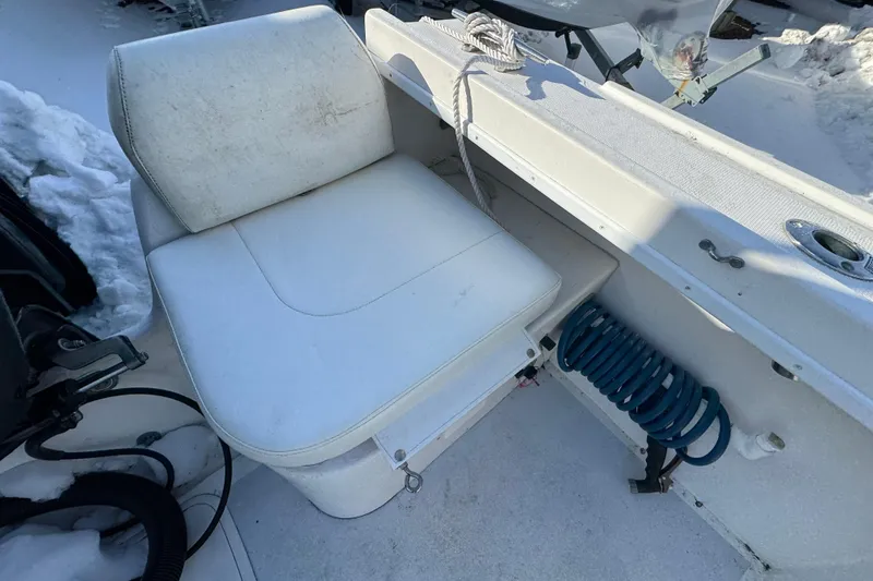 Slide: The Image of 2008 Steiger Craft 23 Miami boat interior with white seating and coiled blue hose. - 19