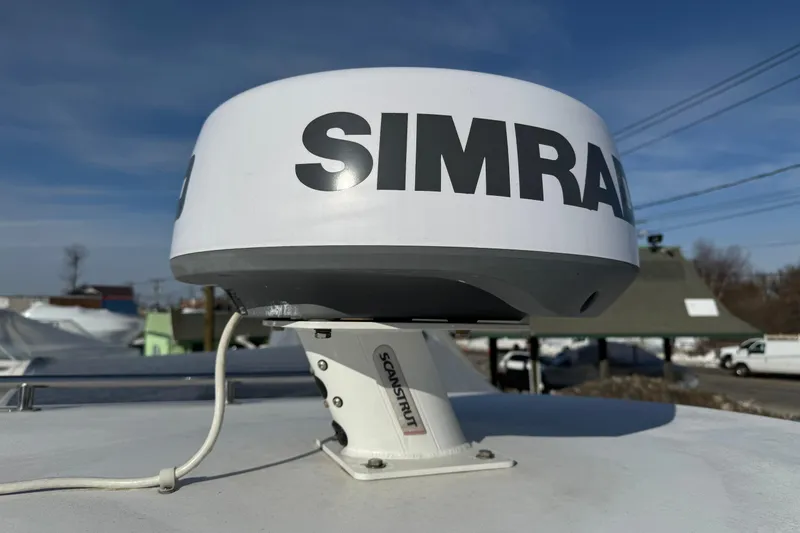 Slide: The Image of Simrad radar on 2008 Steiger Craft 23 Miami boat under clear blue sky. - 23