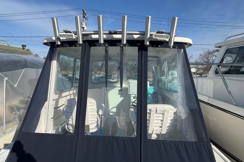Slide: The Image of 2008 Steiger Craft 23 Miami boat with enclosed cabin and rod holders. - 5