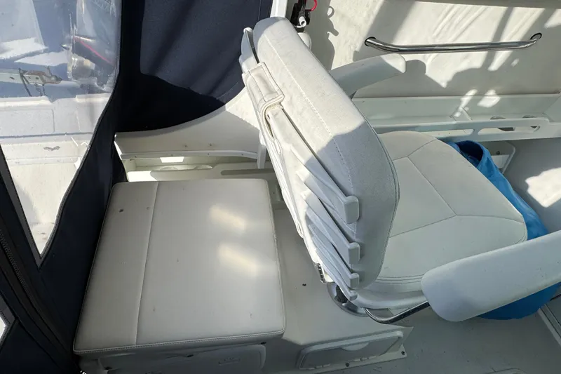 Slide: The Image of 2008 Steiger Craft 23 Miami boat interior with white seating and blue accents. - 6