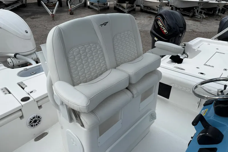Slide: The Image of 2026 Tidewater 2500 Carolina Bay boat with dual cushioned seats and steering console. - 12