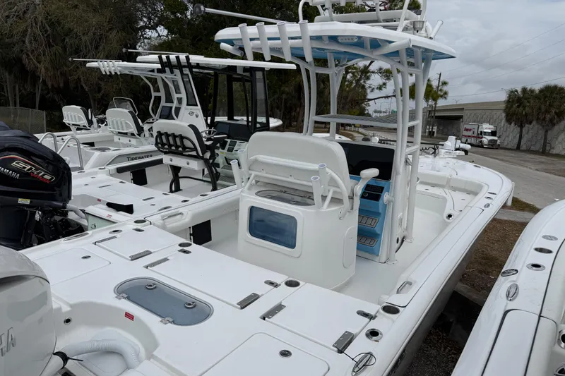 Slide: The Image of 2026 Tidewater 2500 Carolina Bay boat with Yamaha engine, docked outdoors. - 13