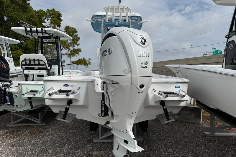 Slide: The Image of 2026 Tidewater 2500 Carolina Bay boat with Yamaha 300 V6 engine displayed outdoors. - 2