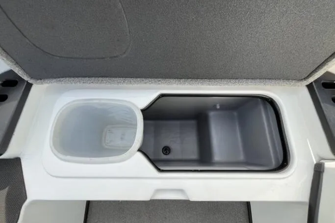 Slide: The Image of 2016 Nitro Z18 boat storage compartment with gray interior and white trim. - 14