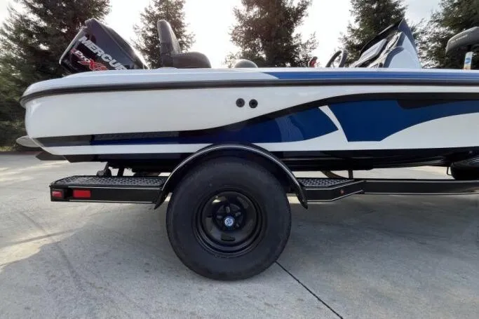 Slide: The Image of 2016 Nitro Z18 boat on trailer, featuring sleek blue and white design. - 3