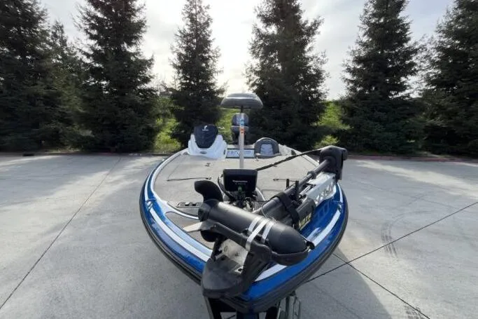 Slide: The Image of 2016 Nitro Z18 boat parked on concrete, surrounded by trees. - 7