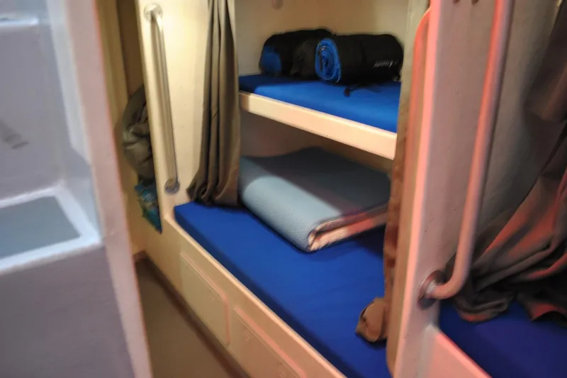 Slide: The Image of Bunk beds with blue mattresses on a 2019 Newton 53 dive boat. - 17