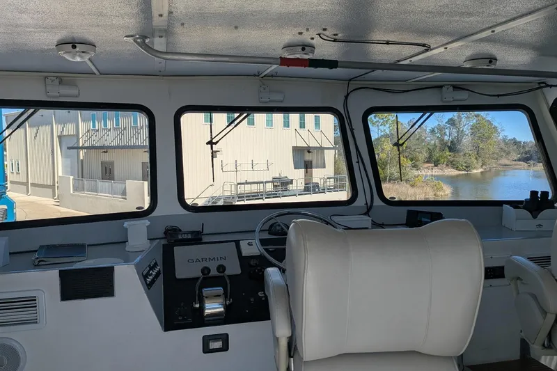 Slide: The Image of Interior view of a 2019 Newton 53 dive boat cockpit with navigation equipment. - 26