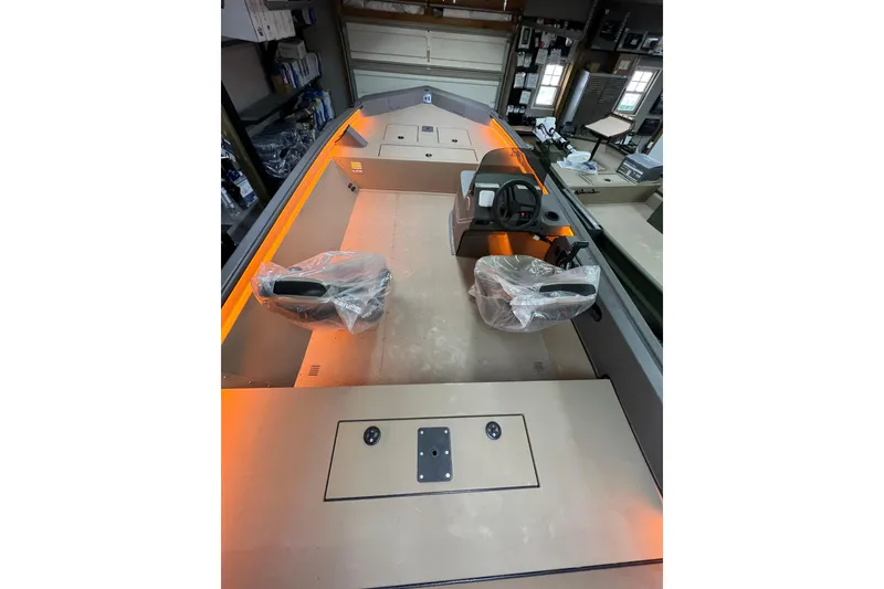 Slide: The Image of 2026 SeaArk Shadow 20T boat interior with dual seats and steering console. - 4