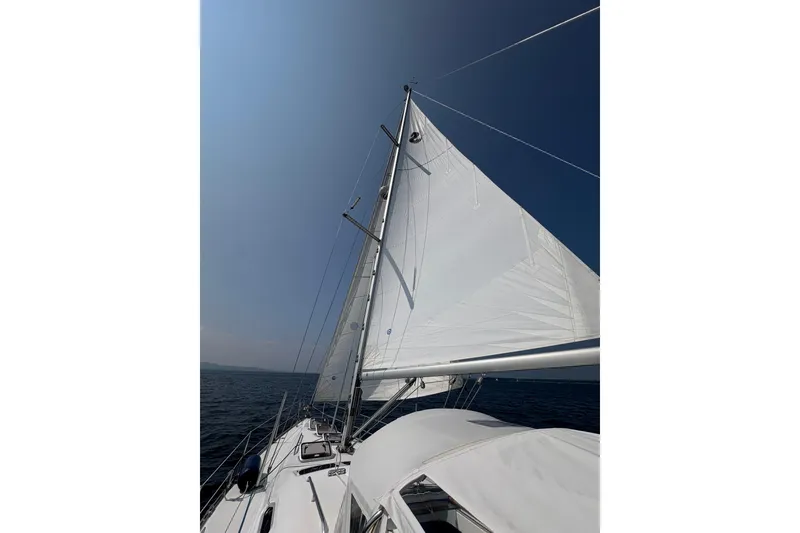 Slide: The Image of 2006 Beneteau Oceanis Clipper 393 sailing on open sea under clear blue sky. - 1