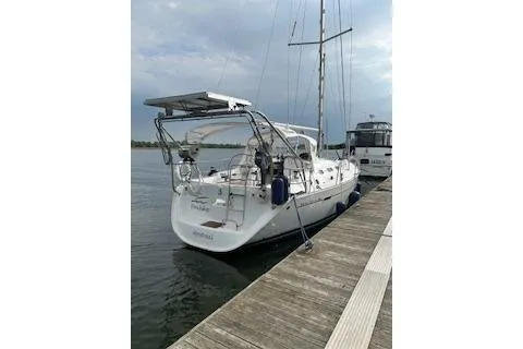 Slide: The Image of 2006 Beneteau Oceanis Clipper 393 docked, showcasing sleek design and spacious deck. - 13