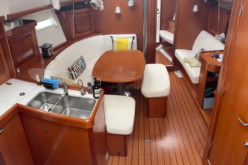 Slide: The Image of Interior of 2006 Beneteau Oceanis Clipper 393 yacht with wood finish and cozy seating area. - 15