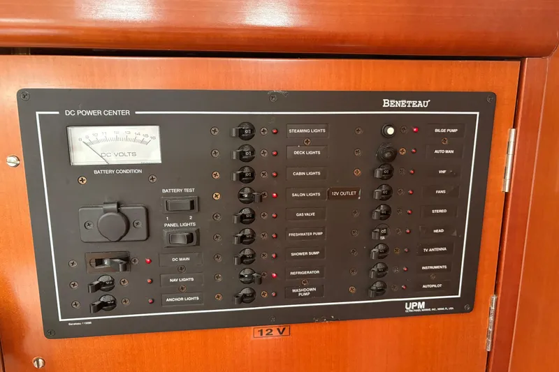 Slide: The Image of Control panel of a 2006 Beneteau Oceanis Clipper 393 yacht, featuring various switches and gauges. - 23