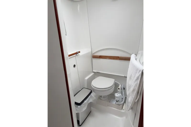 Slide: The Image of Bathroom of 2006 Beneteau Oceanis Clipper 393 yacht, featuring toilet and towel rack. - 25